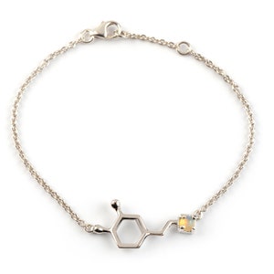 Sterling Silver bracelet of the Dopamine molecule in polished finish. The molecule atom that is on its right end is set with an Opal birthstone.