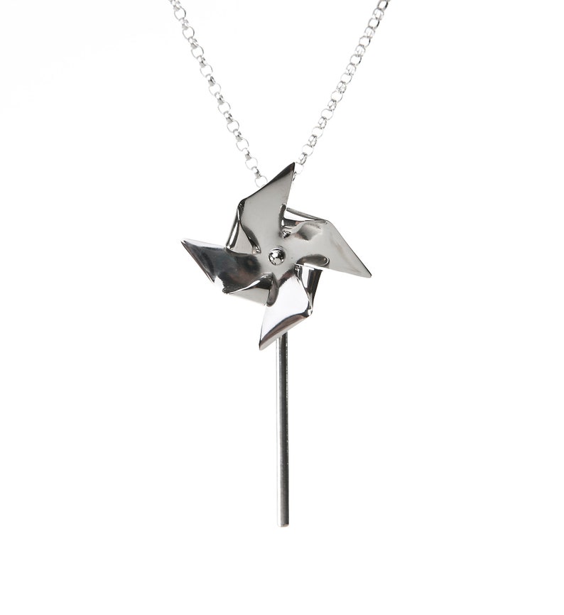 Pinwheel necklace made from Titanium that can actually spin. Hangs from a thin link Sterling Silver chain with a Largentolab clasp.