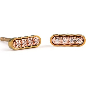Curly bar stud earrings made from Pink Gold colored Titanium in the external part & pin, surrounding the solid gold Rose Gold in its curly center. This is set with tiny white diamonds, 4 in total on each earring. Polished finish.