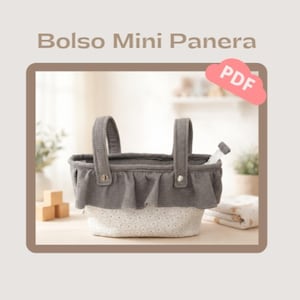 May include: A small, gray fabric basket with two handles and a ruffled top. The bottom half of the basket is white with a floral pattern. The text "Bolso Mini Panera" and a "PDF" icon are visible in the image.