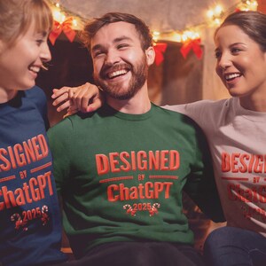 May include: Three people wearing sweatshirts with the text "DESIGNED by ChatGPT 2025" in red. The sweatshirts are navy blue, green, and light pink. The people are smiling and appear to be enjoying themselves.