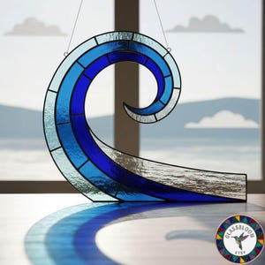 May include: Stained glass wave sculpture in shades of blue, with a curved design. The artwork is suspended by a thin wire, casting a shadow. The piece is a decorative item, suitable for coastal or nautical-themed decor.