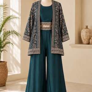 May include: A dark teal three-piece outfit consisting of a sleeveless crop top, wide-leg trousers, and an open-front jacket. The jacket features intricate floral embroidery in muted tones, while the top and trousers have matching embroidered bands.