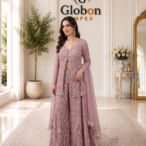 May include: A dusty rose three-piece ensemble featuring a long-sleeved, front-slit tunic, wide-leg trousers, and a matching sheer dupatta. The entire outfit is crafted from intricate floral lace fabric with delicate embroidery and subtle beadwork.