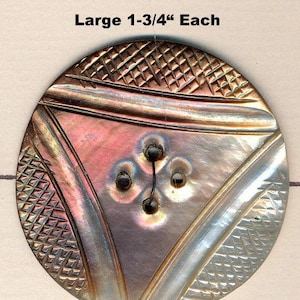 May include: Three large, iridescent buttons with a diameter of 1.75 inches. Each button features a central triangle design with a four-hole pattern and a textured outer edge. The buttons are connected by a thin black thread.