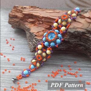 May include: A beaded bracelet with a central blue crystal surrounded by turquoise and yellow beads. The bracelet features orange, purple, and brown accents. The text "PDF Pattern" is visible in the lower right corner.