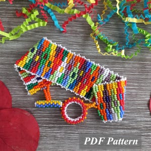 May include: A beaded eyeglass holder in a vibrant array of colors, including red, yellow, green, and blue. The holder is rectangular with a circular loop and a T-shaped support. The text "PDF Pattern" is visible.
