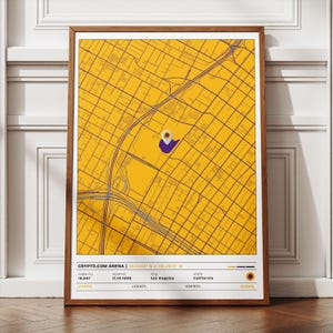 May include: A framed map print of Crypto.com Arena in Los Angeles, California. The map is yellow with purple grid lines and a purple marker. The print includes the arena's name, coordinates, capacity, opening date, and the city and state.