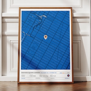 May include: A framed print featuring a blue map of an urban area, with a location marker. The print includes the text "MADISON SQUARE GARDEN" and details such as capacity, opening date, city, and state. The print is in a wooden frame.