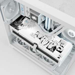 May include: A white computer case with a custom graphics card featuring black and white anime artwork. The artwork includes multiple character illustrations. The case has a clear side panel, showcasing the internal components.