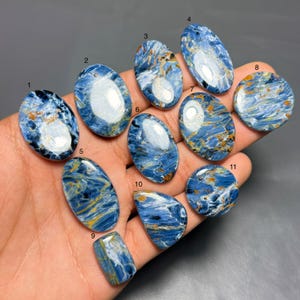 May include: A set of three ceramic mugs with a speckled, matte finish. The mugs are in shades of cream, light gray, and dark gray. Each mug has a simple, minimalist design, perfect for coffee or tea.