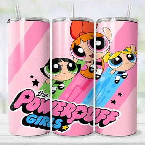 May include: Pink tumbler featuring The Powerpuff Girls cartoon characters. The tumbler has a pink background with diagonal stripes and the words "the POWERPUFF GIRLS" in a stylized font. The tumbler includes a straw.