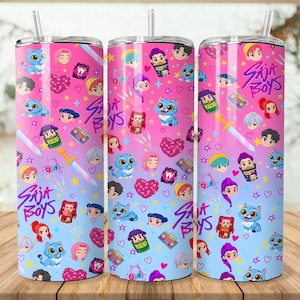 May include: Three stainless steel tumblers with a colorful design. The design features cartoon characters, hearts, stars, and the text "Saja Boys" in a gradient of pink and blue. Each tumbler has a straw.