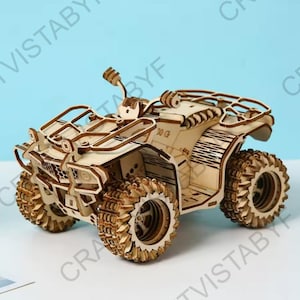 May include: A detailed wooden ATV model, featuring large, textured wheels and a roll cage. The model is constructed from light-coloured wood and appears to be a puzzle or model kit. The ATV has a detailed front end and is a miniature replica.