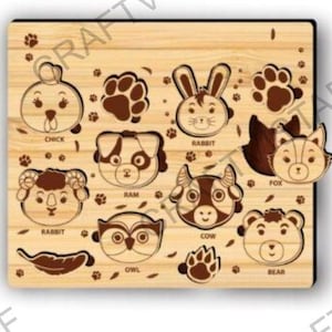 May include: Wooden animal puzzle featuring a chick, rabbit, ram, owl, cow, and bear. The puzzle includes paw prints and animal shapes. The fox is a separate piece. The puzzle is made of light-colored wood.