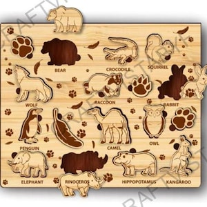 May include: Wooden animal puzzle featuring a bear, wolf, penguin, elephant, and other animals. The puzzle pieces are removable and shaped like the animals. The background is light brown with paw prints and leaf details.