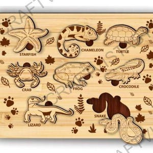May include: Wooden animal puzzle featuring a starfish, chameleon, turtle, crab, frog, crocodile, lizard, and snake. Each animal is a separate piece with the animal's name printed below. The puzzle is decorated with paw prints and leaves.