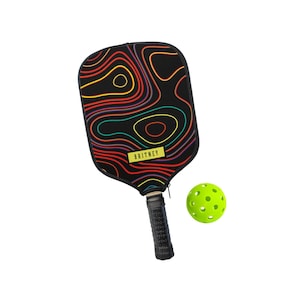 May include: A black pickleball paddle with a colorful, abstract design and the name "BRITNEY" on a yellow label. A neon green pickleball is next to the paddle. The paddle has a black grip.