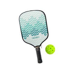 May include: A pickleball paddle with a white and teal pattern and the name "BRITNEY" printed on the face. The paddle has a black handle and is paired with a neon green pickleball.