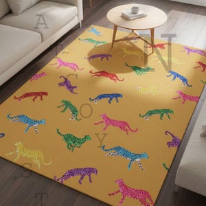 May include: Mustard yellow rectangular area rug featuring a repeating pattern of colorful cheetahs. The cheetahs are in various colors, including pink, blue, green, and purple, with a speckled design. The rug is placed on a dark wood floor.