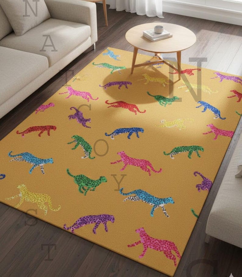 May include: Mustard yellow rectangular area rug featuring a repeating pattern of colorful cheetahs. The cheetahs are in various colors, including pink, blue, green, and purple, with a speckled design. The rug is placed on a dark wood floor.
