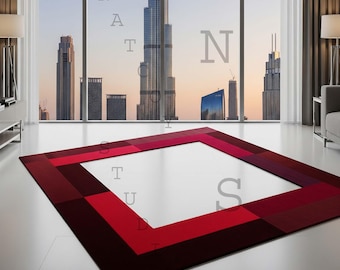 May include: A rectangular red rug with a square center, featuring a geometric pattern of varying shades of red. The rug is placed on a white floor in front of a large window with a city skyline view.