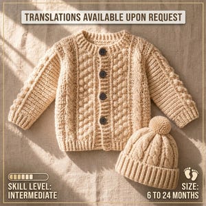 May include: A beige long-sleeved knit cardigan with four dark buttons and a matching knit beanie with a pom-pom. The text on the image reads: TRANSLATIONS AVAILABLE UPON REQUEST, SKILL LEVEL: INTERMEDIATE, SIZE: 6 TO 24 MONTHS.