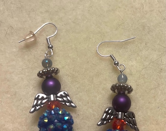 Dangle Angel earrings - Big faceted blu AB bead with orange, purple green. Blue and silver. 1.25” long