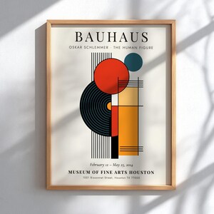 May include: A framed Bauhaus art print with a geometric design in red, black, yellow, and blue. The print includes the text "BAUHAUS" and "OSKAR SCHLEMMER - THE HUMAN FIGURE". The Museum of Fine Arts Houston is also listed.