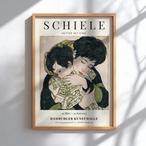 May include: A framed art print featuring Egon Schiele's Mutter mit Kind. The illustration depicts a person with dark hair embracing a child. Text at the top reads SCHIELE MUTTER MIT KIND. Bottom text includes 22 März - 30 Juni 2013 HAMBURGER KUNSTHALLE.