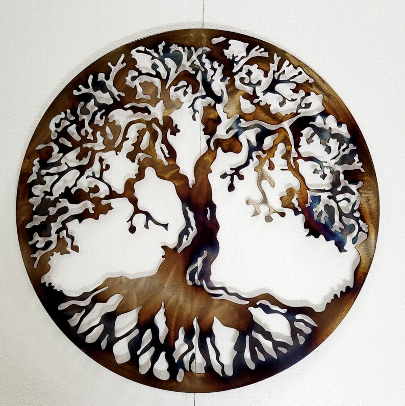 May include: A metal wall art sculpture of a tree of life with brown and black metal branches and roots. The tree is circular in shape and has a rustic, distressed look.