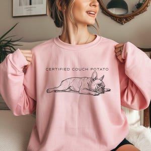 Minimalist line art of a French Bulldog splooting on a sweatshirt