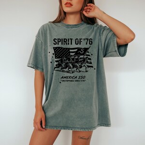 Distressed patriotic graphic tee with paint splatter effects around soldiers