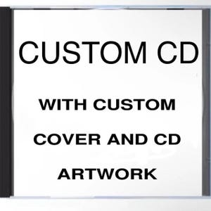 May include: A clear CD case with a white insert. Bold black text reads "CUSTOM CD WITH CUSTOM COVER AND CD ARTWORK". The CD case is rectangular and has a black spine.