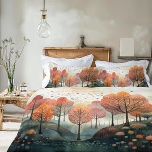 May include: A watercolor-style bedding set featuring a forest scene with trees in shades of orange, red, and brown. The duvet cover and pillowcases display a landscape with a river and a sky filled with birds. The overall theme is nature and autumn.