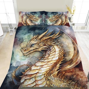 May include: A bedding set with a watercolour illustration of a golden dragon with blue eyes. The set includes a duvet cover and two pillowcases, all featuring the dragon design. The dragon is set against a dark, watercolour background.