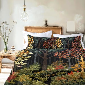 May include: A bed with a forest-themed quilt and pillow set. The bedding features a dark background with a detailed print of trees, foliage, and autumn colors. The pillows and quilt are decorated with a repeating pattern of trees and leaves.