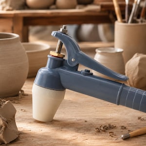 May include: A blue handheld clay extruder tool featuring a white conical nozzle, a metallic plunger mechanism with a nut at the top, and a lever-action handle. The tool is constructed from smooth plastic and metal components for shaping clay.