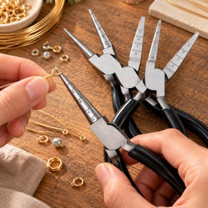 May include: A set of multi-step bail making pliers with black handles and silver metal jaws featuring graduated cylindrical tiers marked with numbers 2 through 8. The pliers are used to shape wire into loops and rings for jewelry making projects.