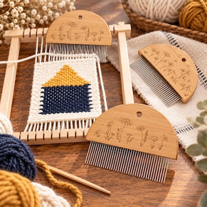 May include: Three semi-circular wooden weaving combs with engraved floral patterns and metal teeth. One comb is positioned on a small wooden loom frame with a partially woven tapestry featuring a yellow triangle and a navy blue square.