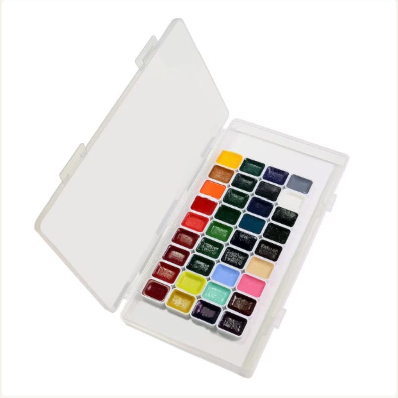 36-color watercolor paint palette with bright artist pigments arranged inside compact storage case.
