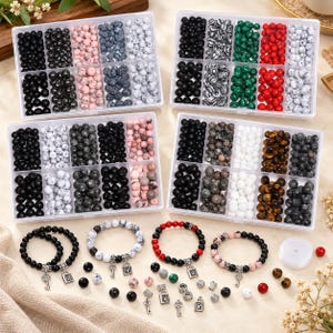 May include: Four clear plastic storage containers filled with assorted round beads in various colours and textures, including black, white, pink, red, green, and brown. Four finished beaded bracelets with silver-toned key charms are also included.