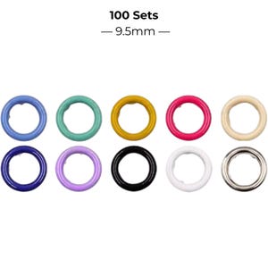 May include: A set of 100 metal grommets measuring 9.5mm in diameter. The collection includes ten distinct colors: light blue, teal, mustard yellow, hot pink, cream, dark blue, lavender, black, white, and a metallic silver finish.