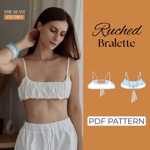 May include: A white ruched bralette PDF pattern by The Seam Studio. The image displays a white crop top with thin straps and gathered fabric, alongside a technical line drawing showing the front and back views with tie-back details.