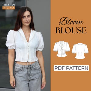 May include: A white short-sleeved blouse with a collared neckline and tie-up front, worn with grey jeans. The image includes the text "Bloom BLOUSE" and "PDF PATTERN" on a brown background, along with blouse pattern illustrations.