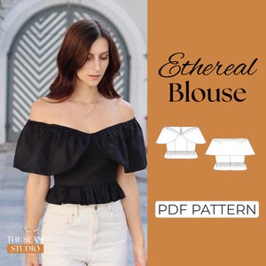 May include: A black off-the-shoulder blouse with a ruffled neckline and hem. The image includes the text "Ethereal Blouse" and "PDF PATTERN". The blouse is paired with white pants. The Seam Studio logo is in the bottom left corner.
