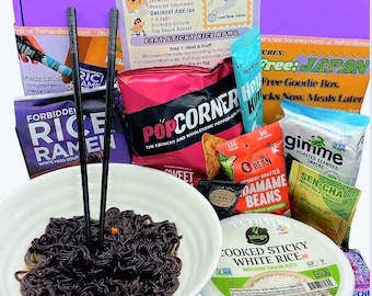 May include: A collection of Japanese snacks and ingredients, including ramen, popcorn, seaweed snacks, and sticky rice. The image features a bowl of black noodles with chopsticks, and various packaged food items. The box is labeled "Free: JAPAN".