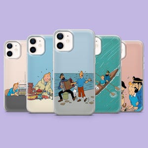 May include: Five iPhone cases with clear borders, each displaying a different comic book illustration. The cases feature a range of background colours, including blue, pink, and green. The illustrations depict characters, animals, and scenes from the comic book.