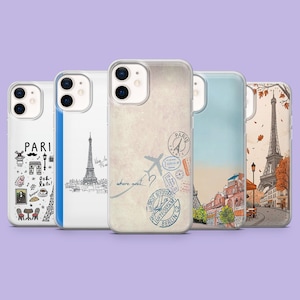 May include: A collection of five phone cases featuring travel-themed designs. The cases showcase illustrations of the Eiffel Tower, Parisian landmarks, and travel stamps. The color palette includes white, blue, and beige.