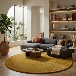 Mustard yellow round hand tufted wool rug in modern living room under sofa and coffee table, minimalist Scandinavian area rug decor